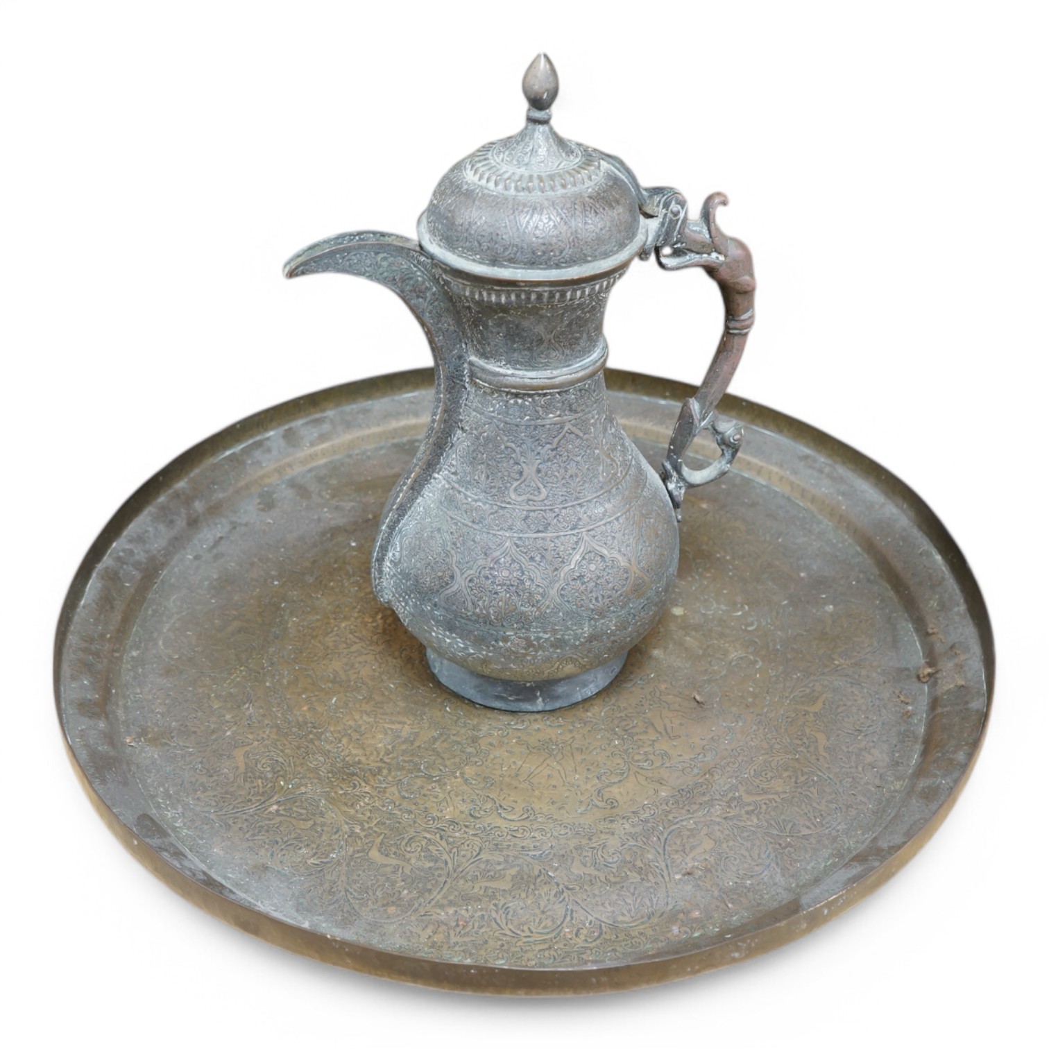 A Kashmiri brass lidded tea pot and tray, teapot 35cm high, tray 50cm diameter. Condition - fair to good